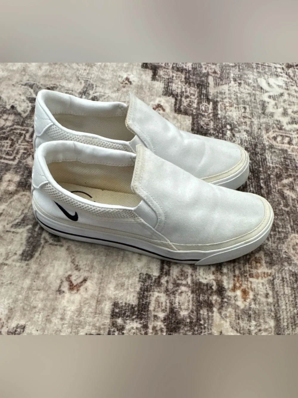 Nike Women’s White Slip-On Sneakers with Black Swoosh Accent